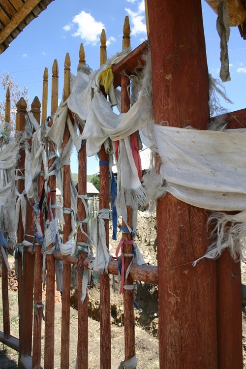 Prayer flags tied to a fence.