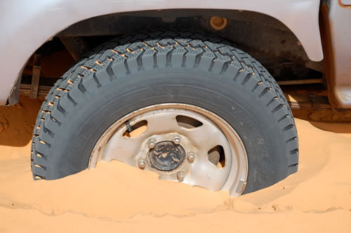 4WD tire wheel stuck in sand in Mauritania.