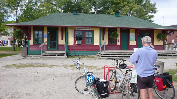 Man with cycle and map at the Annonciation railway house at Riviere-Rouge.