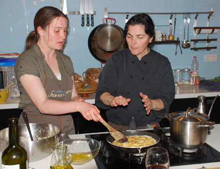 Barcelona cooking class where a student is cooking her tortilla.