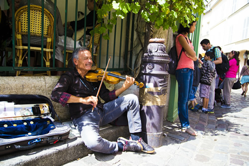 A street musician playing violin in Paris.