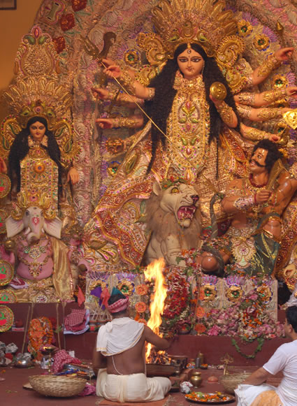 Priest performing ceremony during Durga Puja in India.