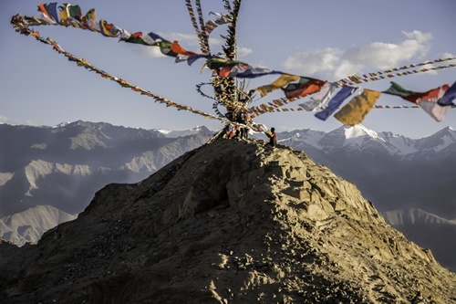 Hanging flags on top of a mountain in Lahahk, India.