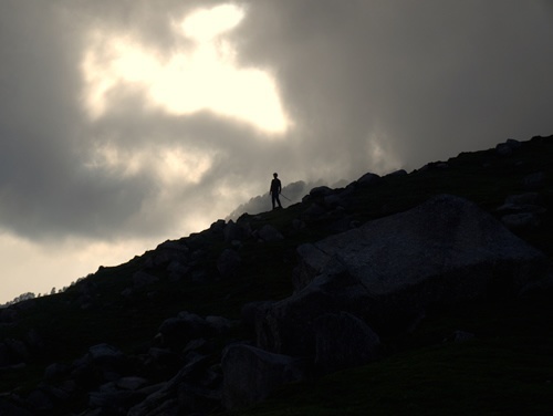 Standing on a hill in the evening.