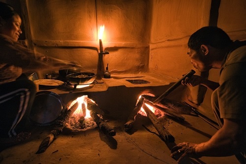 Cooking in a built-in stove in a Himalayan house.