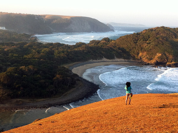 Woman gazing out at the ocean alone.