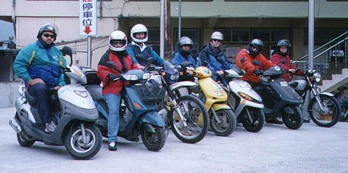 A group of men riding scooters in Taiwan.