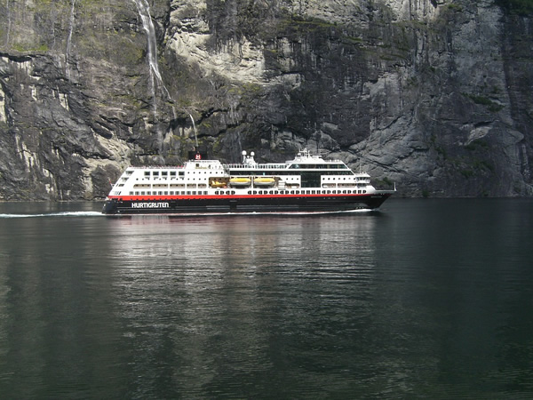 Hurtigruten in Norway passing by a fjord.