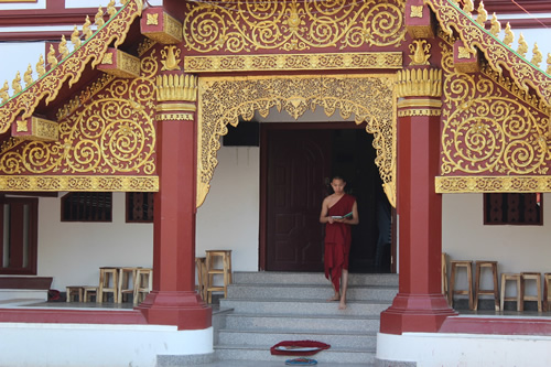 Monk walking out of a temple in Chiang Mai.