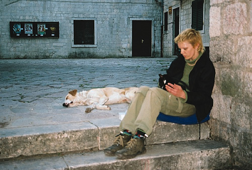 A woman reading on an old step in Kotor, Montenegro.