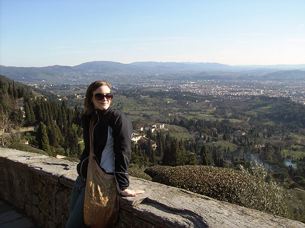 The author standing near a wall overlooking Fiesole, a small village near Florence.