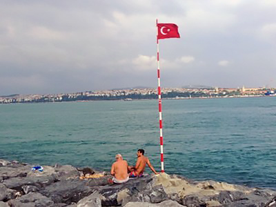 Istanbul along rocky shore.