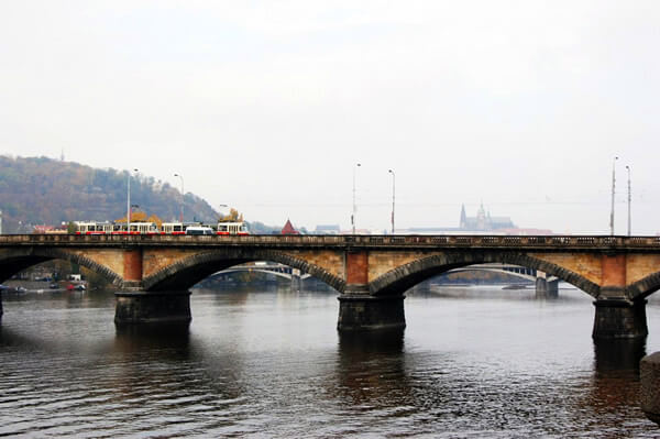 Tram on Prague, Czech Republic bridge in the fog.