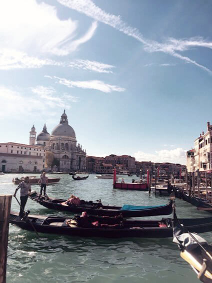 Gondolas in the water in Venice, Italy seen from Grand Canal.