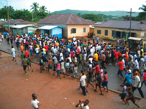 A crowd in a soccer victory parade in Ghana.